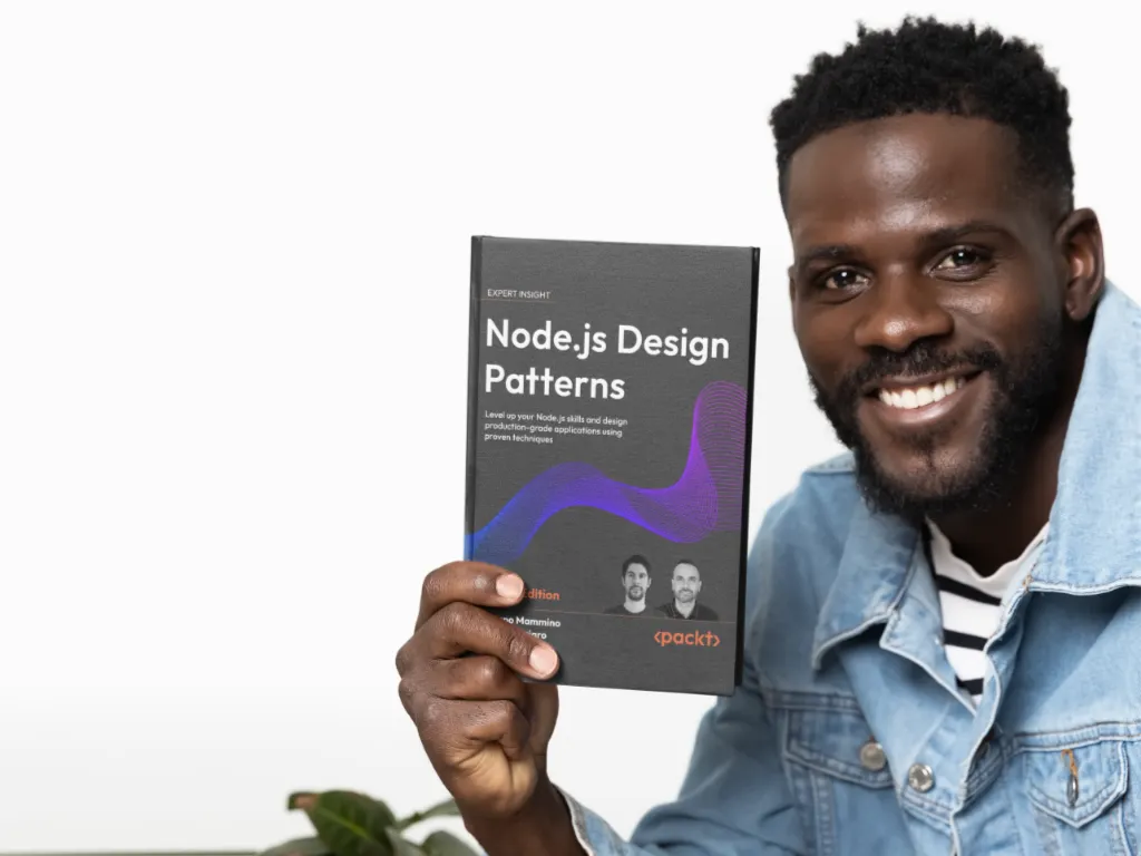 Smiling man presenting the 'Node.js Design Patterns – Fourth Edition' book toward the camera in a bright studio setting; cover and Packt logo clearly shown.